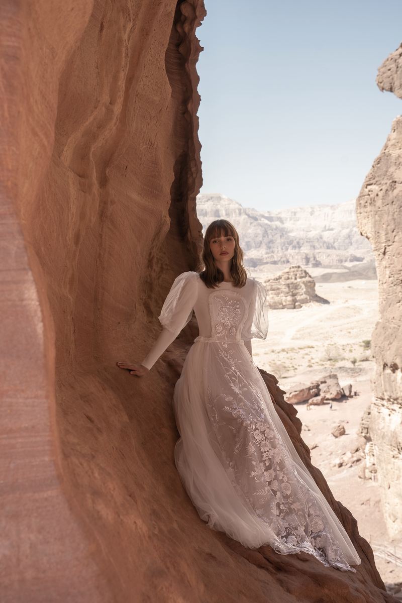 Desert Horizon — puffed-sleeve gown on a canyon ledge